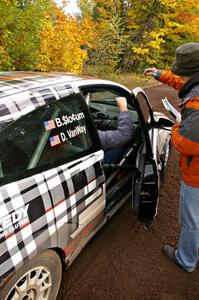 Ben Slocum hands his time card to workers at the start of Delaware 1, SS11. He navigated for Dillon van way in a Ford Focus.