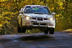 Heath Nunnemacher / Mike Rossey catch nice air at the midpoint jump on Brockway Mtn. 1, SS13, in their Subaru WRX STi.