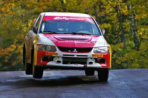 Arkadiusz Gruszka / Lukasz Wronski catch air at the midpoint jump on Brockway Mtn. 1, SS13, in their Mitsubishi Lancer Evo 9.