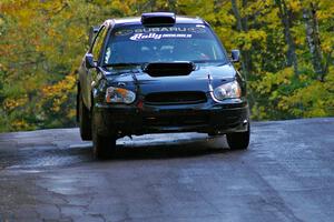 Vio Dobasu / Rob Amato catch a little air at the midpoint jump on Brockway Mtn. 1, SS13, in their Subaru WRX STi.