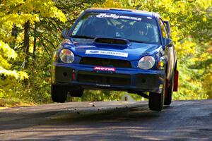 The Janusz Topor / Michal Kaminski Subaru WRX STi catches air at the midpoint jump on Brockway Mtn. 1, SS13.