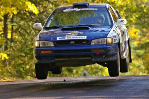Mason Moyle / Scott Putnam catch air in their Subaru Impreza at the midpoint jump on Brockway Mtn. 1, SS13.