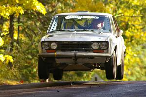 Jim Scray / Colin Vickman catch nice air at the midpoint jump on Brockway Mtn. 1, SS13, in their Datsun 510.