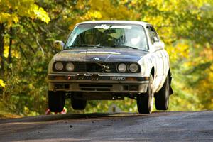 Bill Caswell / Elliott Sherwood catch air at the midpoint jump on Brockway Mtn. 1, SS13, in their BMW 318i.
