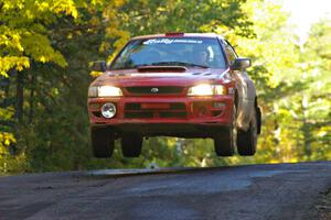 Dustin Kasten / Corina Soto catch nice air in their at the midpoint jump on Brockway Mtn. 2, SS16, in their Subaru Impreza.