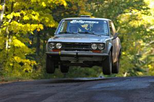 Jim Scray / Colin Vickman catch nice air at the midpoint jump on Brockway Mtn. 2, SS16, in their Datsun 510.