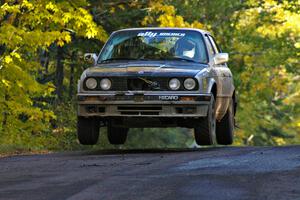 Bill Caswell / Elliott Sherwood catch air at the midpoint jump on Brockway Mtn. 2, SS16, in their BMW 318i.