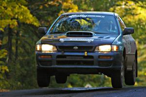 Don Kennedy / Matt Kennedy catch a little air at the midpoint jump on Brockway Mtn. 2, SS16, in their Subaru Impreza.