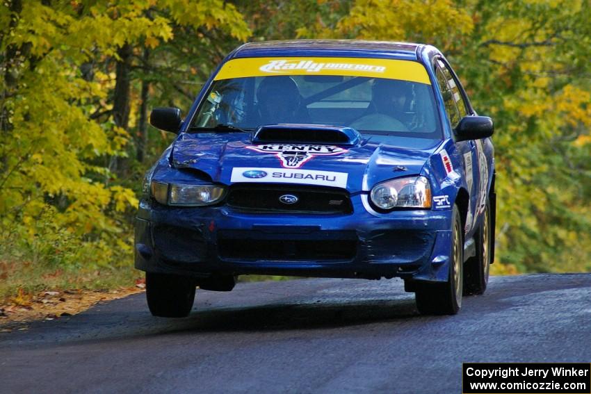 Kenny Bartram / Dennis Hotson catch minimal air at the midpoint jump on Brockway 1, SS13, in their Subaru WRX STi.