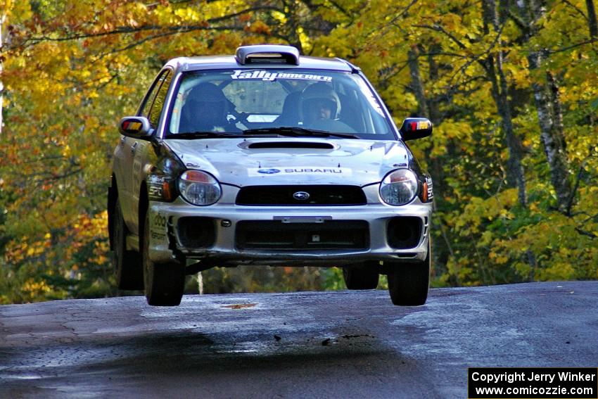 Evan Cline / Jason Grahn catch nice air at the midpoint jump on Brockway Mtn. 1, SS13, in their Subaru Impreza.