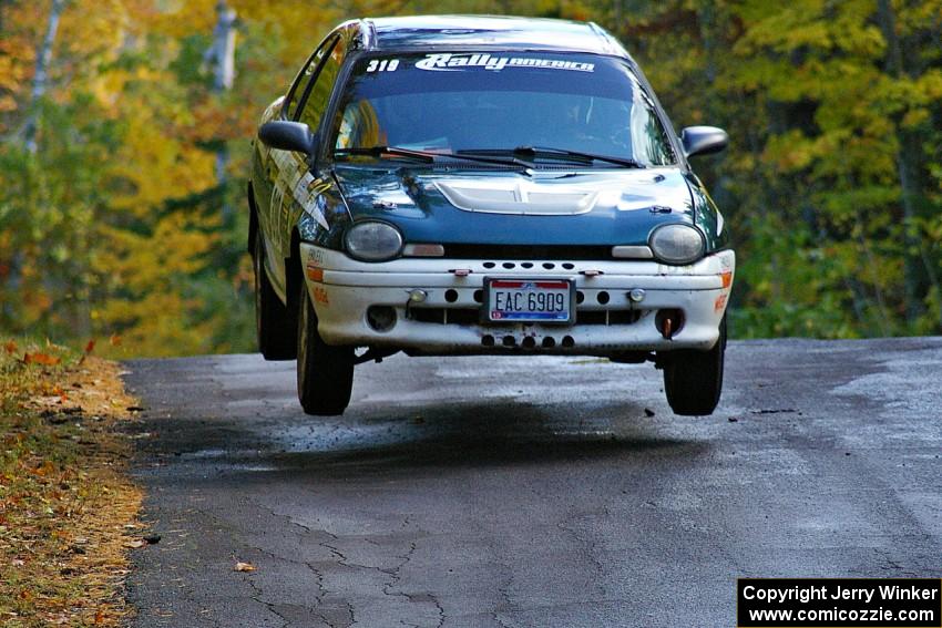 Chris Greenhouse / Don DeRose catch nice air in their Plymouth Neon on the midpoint jump of Brockway Mtn. 1, SS13.