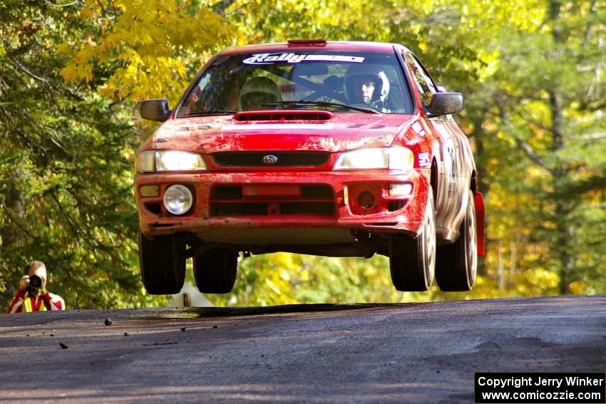 Dustin Kasten / Corina Soto catch nice air in their at the midpoint jump on Brockway Mtn. 1, SS13, in their Subaru Impreza.