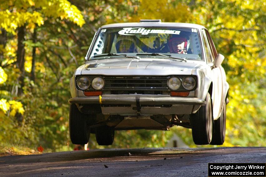 Jim Scray / Colin Vickman catch nice air at the midpoint jump on Brockway Mtn. 1, SS13, in their Datsun 510.