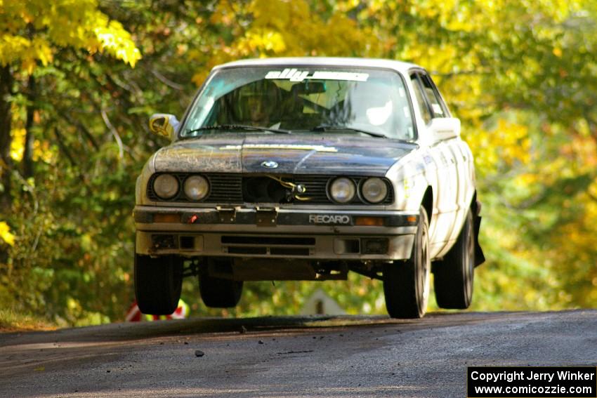 Bill Caswell / Elliott Sherwood catch air at the midpoint jump on Brockway Mtn. 1, SS13, in their BMW 318i.