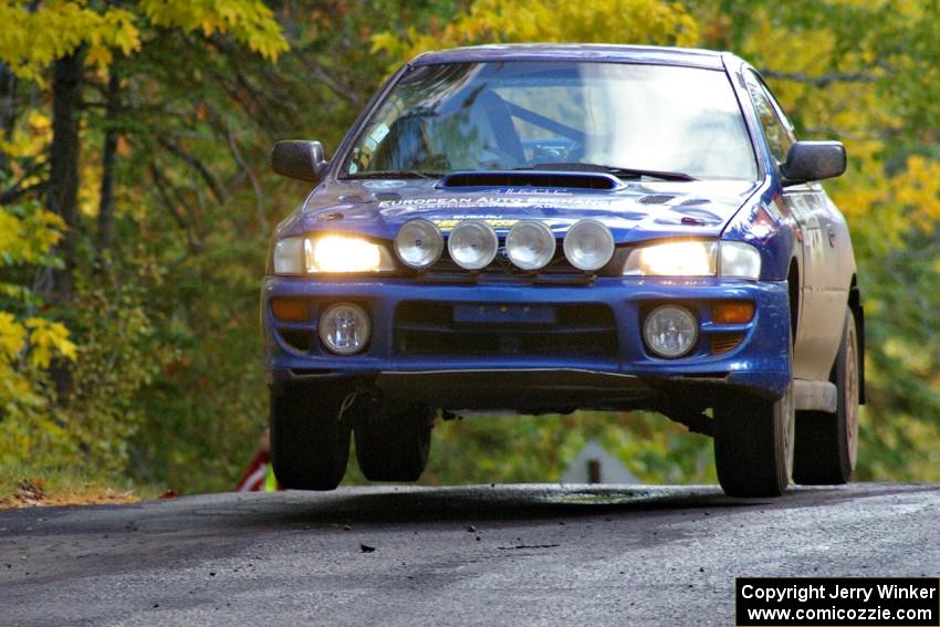 Kazimierz Pudelek / Michal Nawracaj catch a little air at the midpoint jump on Brockway Mtn. 1, SS13, in their Subaru Impreza.