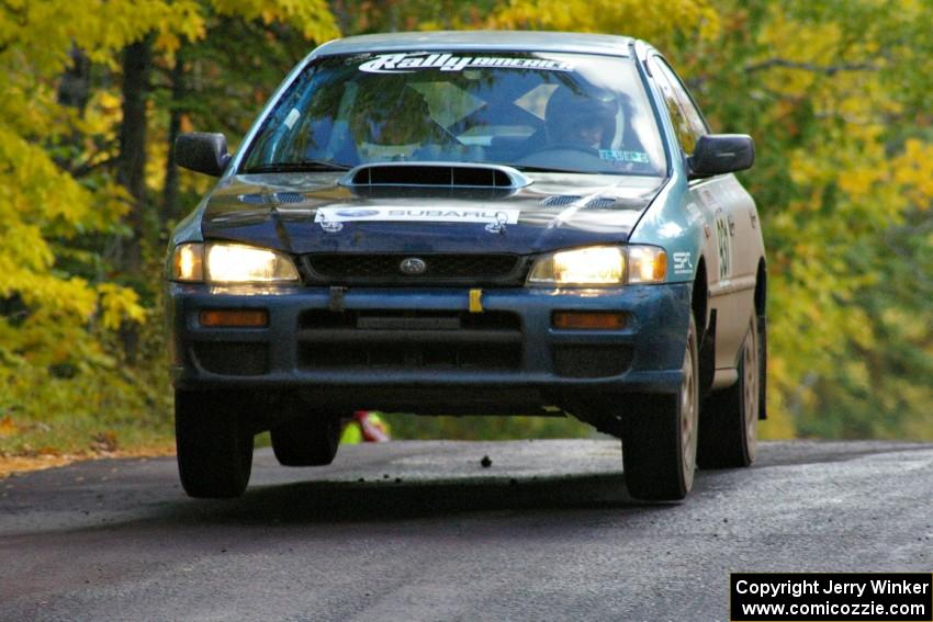 Don Kennedy / Matt Kennedy catch a little air at the midpoint jump on Brockway Mtn. 1, SS13, in their Subaru Impreza.