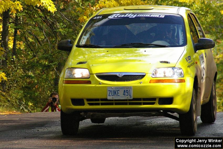 Jim Stevens / Marianne Stevens get the backend light at the midpoint jump on Brockway Mtn. 1, SS13, in their Suzuki Swift.