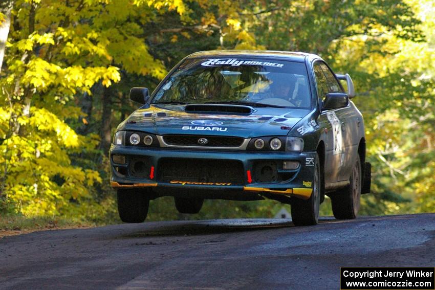 Jaroslaw Sozanski / Bartosz Sawicki catch a little air in their Subaru Impreza RS at the midpoint jump on Brockway Mtn. 2, SS16.