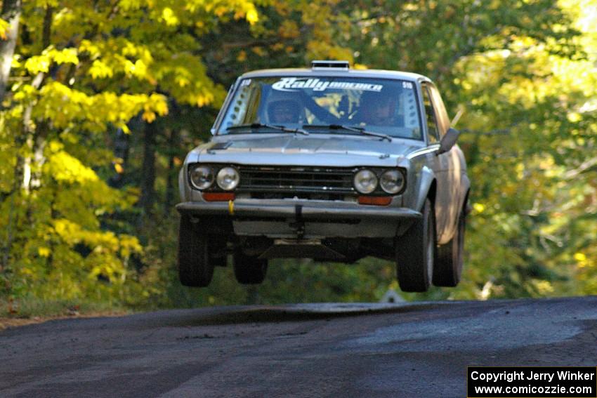 Jim Scray / Colin Vickman catch nice air at the midpoint jump on Brockway Mtn. 2, SS16, in their Datsun 510.