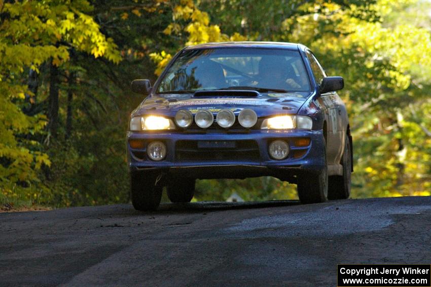 Kazimierz Pudelek / Michal Nawracaj take it easy at the midpoint jump on Brockway Mtn. 2, SS16, in their Subaru Impreza.