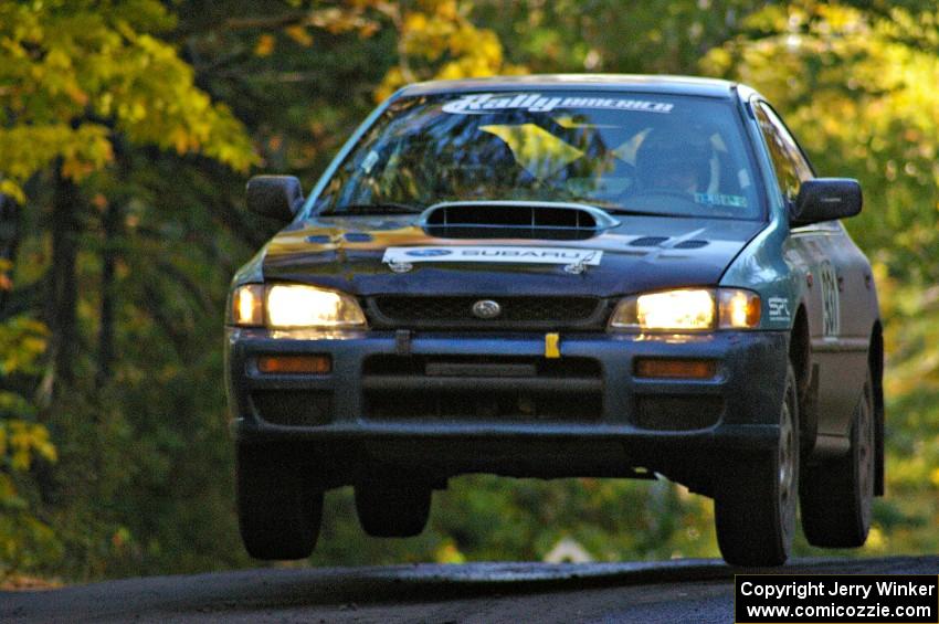 Don Kennedy / Matt Kennedy catch a little air at the midpoint jump on Brockway Mtn. 2, SS16, in their Subaru Impreza.