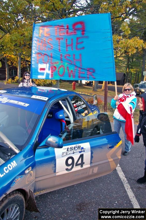 Polish fans surround the Piotr Fetela / Dariusz Belzowski Subaru Impreza after the finish. (1)