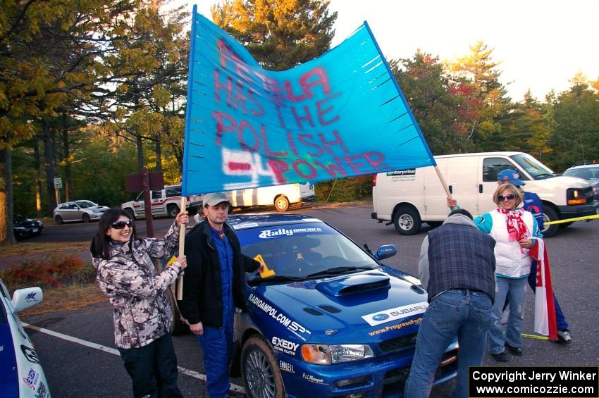 Polish fans surround the Piotr Fetela / Dariusz Belzowski Subaru Impreza after the finish. (2)