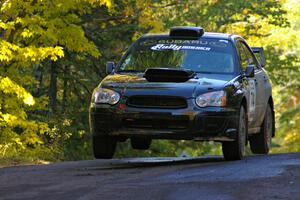 Vio Dobasu / Rob Amato catch some air at the midpoint jump on Brockway Mtn. 2, SS16, in their Subaru WRX STi.