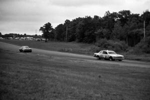 Butch Goff's Chevy Malibu ahead of Lyn St. James's Mercury Capri into 7/8.