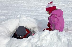 Making a tunnel in the snowbank on the lake access road.