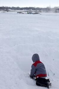 Playing in the snow while the race goes on.