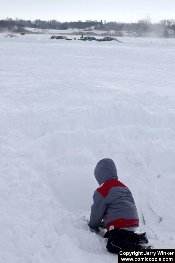 Playing in the snow while the race goes on.