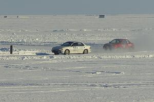 The Kevin Beck / Brent Carlson and Mark Utecht / Jay Luehmann Subaru Imprezas on the back of the course.