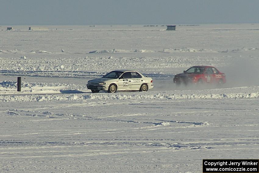 The Kevin Beck / Brent Carlson and Mark Utecht / Jay Luehmann Subaru Imprezas on the back of the course.