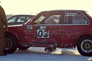The Pete Tavenier / Bruce Powell BMW 318i sports heavy damage to the driver's door.