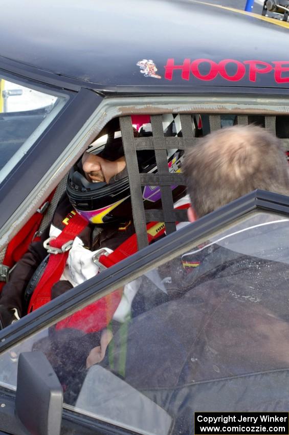 Don Hupe belts Marco Martinez into their Mazda RX-7.