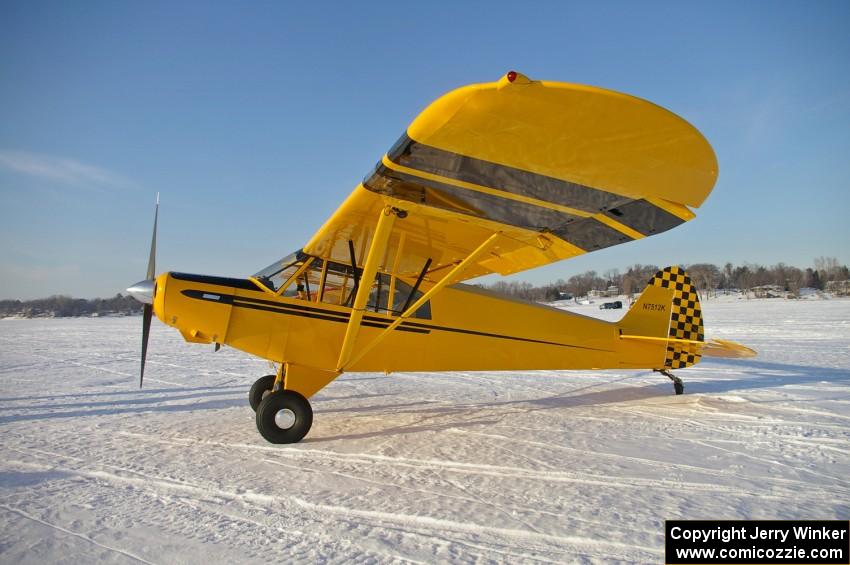 A Piper Cub landed on the lake.