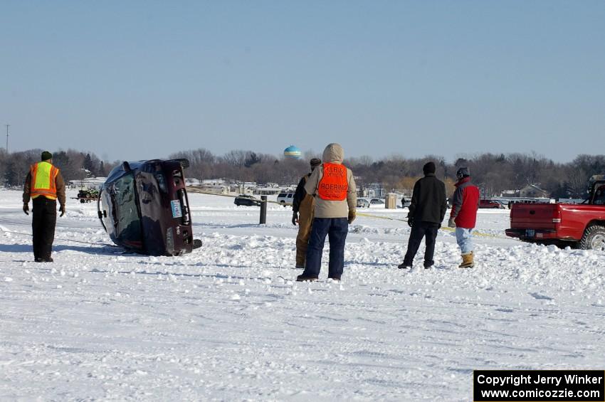 The Bonnie Stoehr / Jake Weber / Pete Weber Mitsubishi Eclipse is flipped back over.