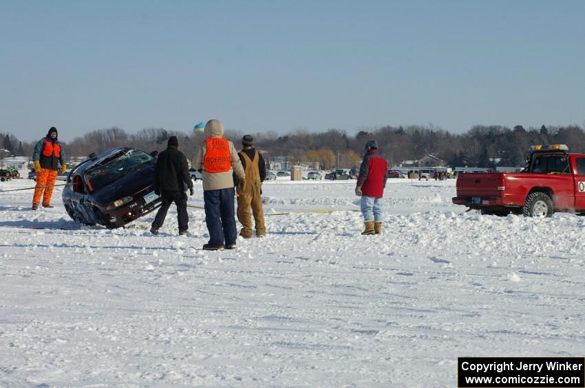 The Bonnie Stoehr / Jake Weber / Pete Weber Mitsubishi Eclipse is flipped back over.