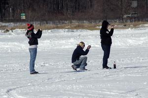 Bonnie Stoehr (in the middle) and friends take photos during the solo race.