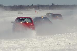 The Mark Utecht / Tom Fuehrer Subaru Impreza trails three other cars' ice dust.