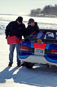 Chris Orr and Andy Orr fuel up their Mazda 323GTX.