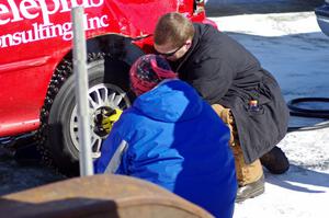 Amy Springer and Will Cammack work on the Mark Utecht / Tom Fuehrer Subaru Impreza before the enduro.