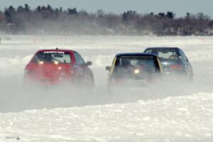 Three cars battle out of turn two.