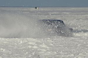 An unknown car slings snow.