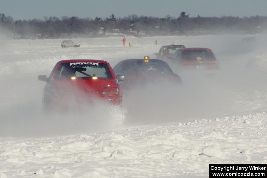 The Mark Utecht / Tom Fuehrer Subaru Impreza trails three other cars' ice dust.