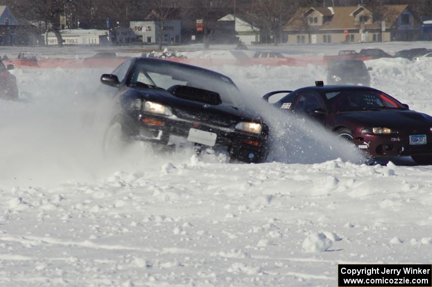 The Tim Stone / Dan Gervais / Ryan Rose Subaru Impreza hits the bank as Bonnie Stoehr / Jake Weber Mitsubishi Eclipse passes.