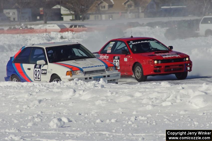 Chris Orr / Terry Orr Mazda 323GTX and Mark Utecht / Tom Fuehrer Subaru Impreza go side by side into turn two.