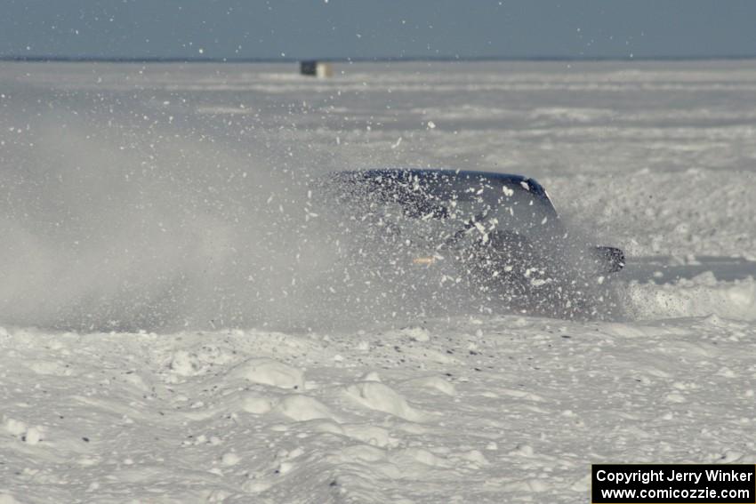 An unknown car slings snow.