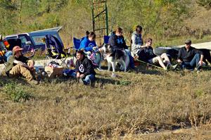 Folks sitting at the side of the course watching the action.